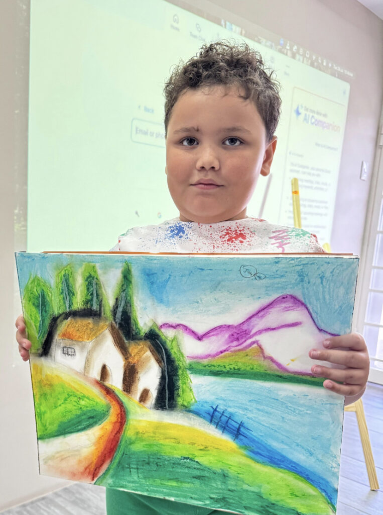 kid holding painting from online art classes