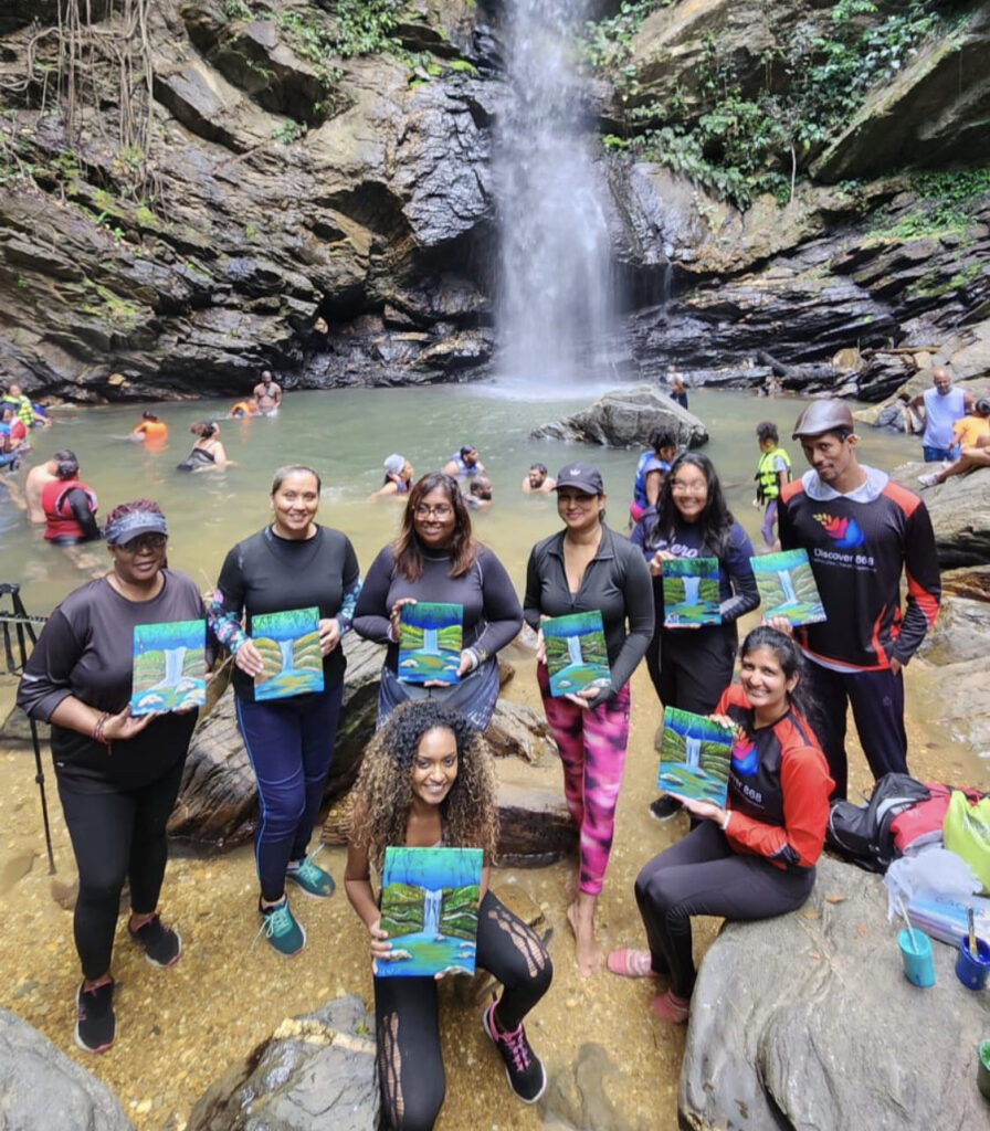 Group photo of art students doing a sip and Paint event at a waterfall